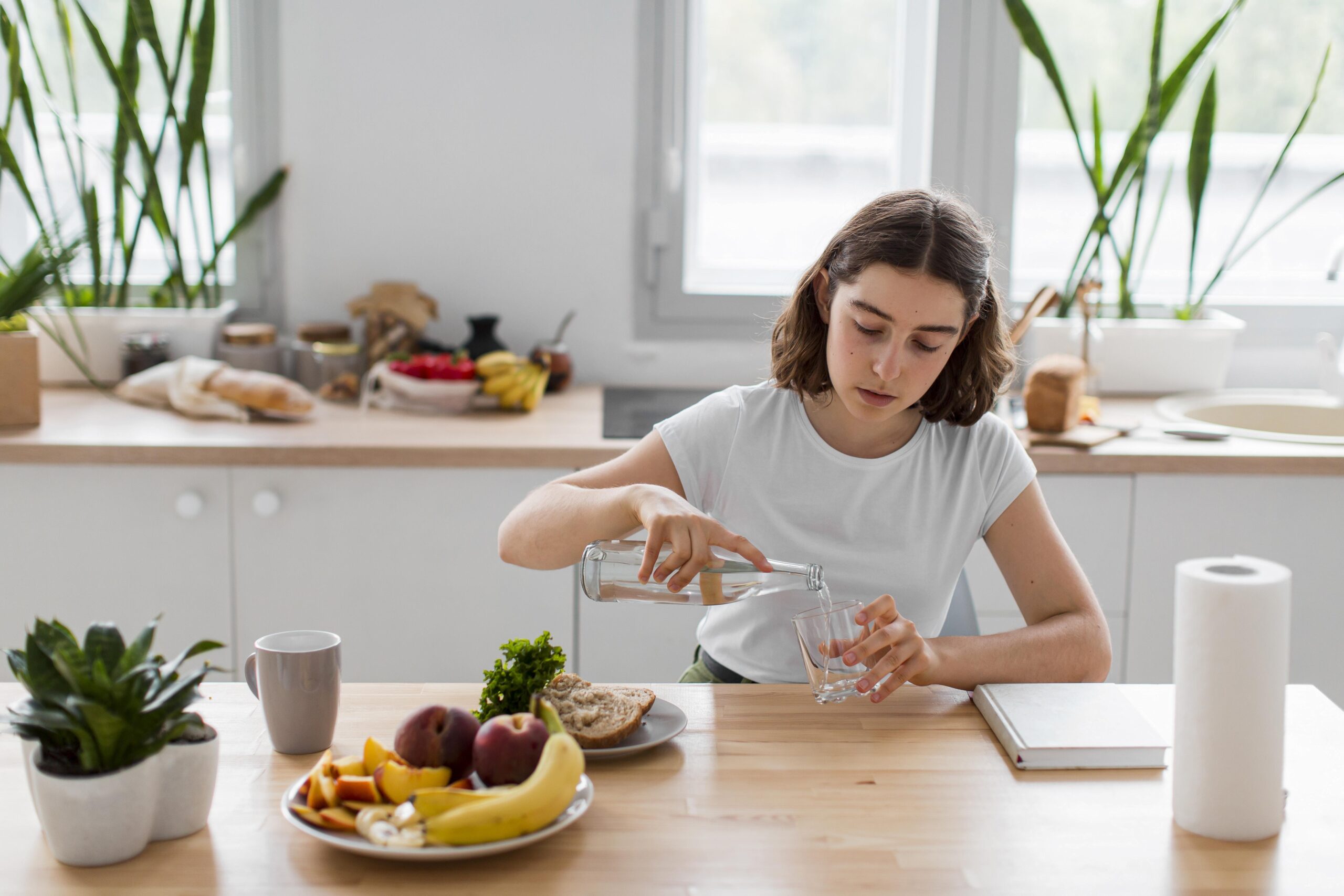 Young woman mitigating semaglutide side-effects by drinking water and eating healthy meals.